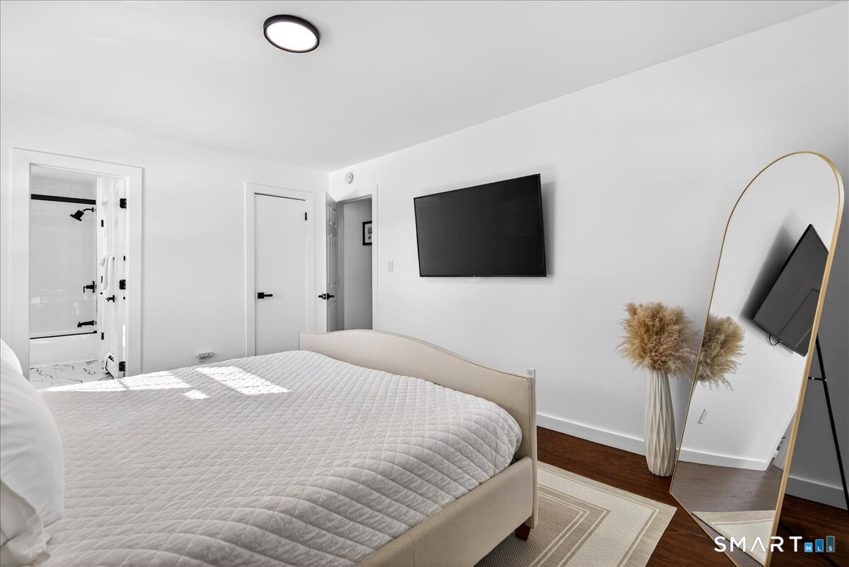 114 Daniel Road Hamden, CT 06517 - Photo 20 of 32 a bedroom with a bed and a flat screen tv