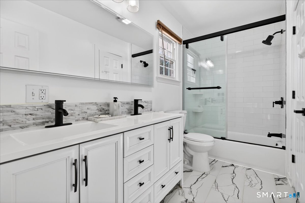 114 Daniel Road Hamden, CT 06517 - Photo 21 of 32 a bathroom with a granite countertop sink a toilet and shower