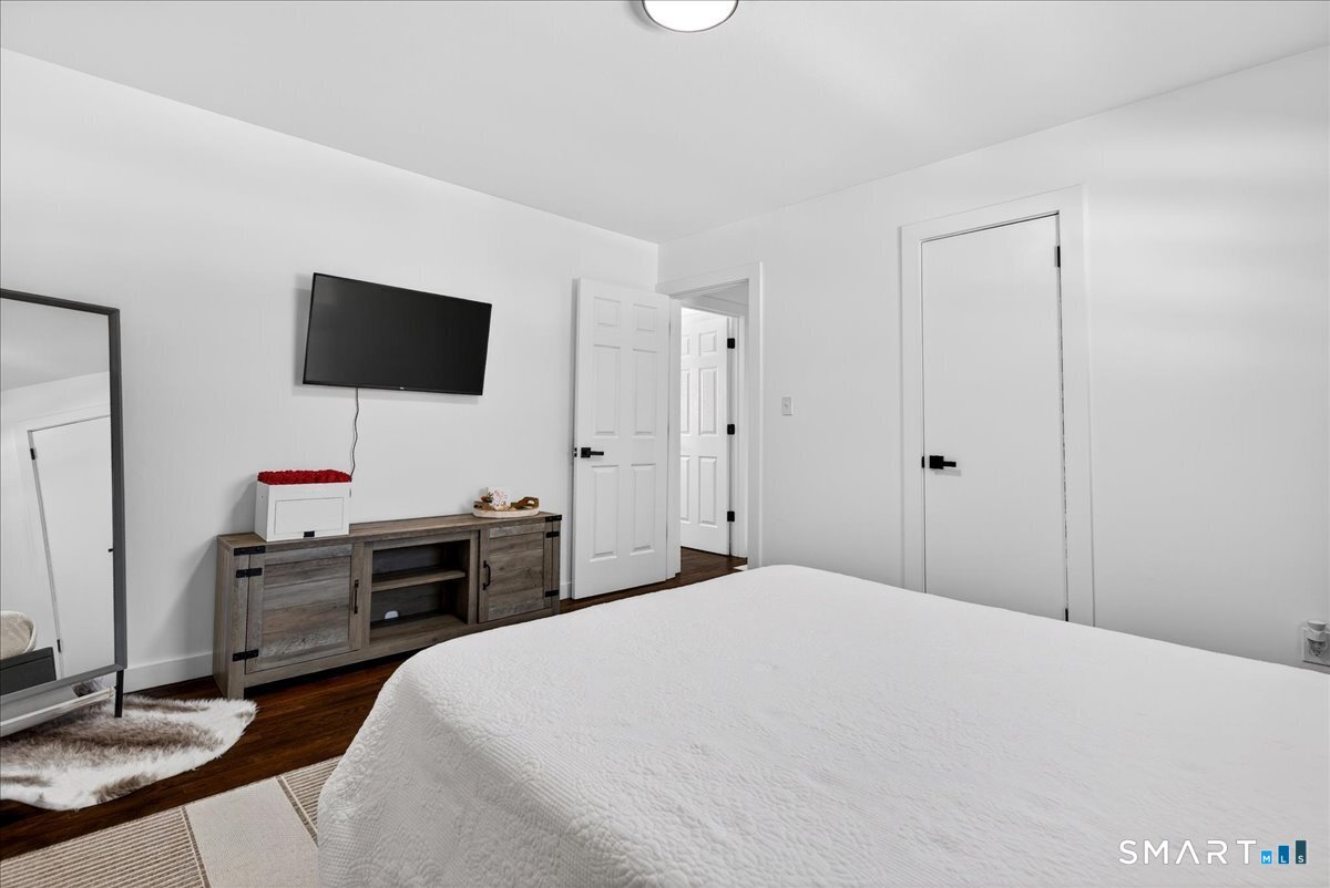 114 Daniel Road Hamden, CT 06517 - Photo 24 of 32 a bedroom with a bed and a flat screen tv