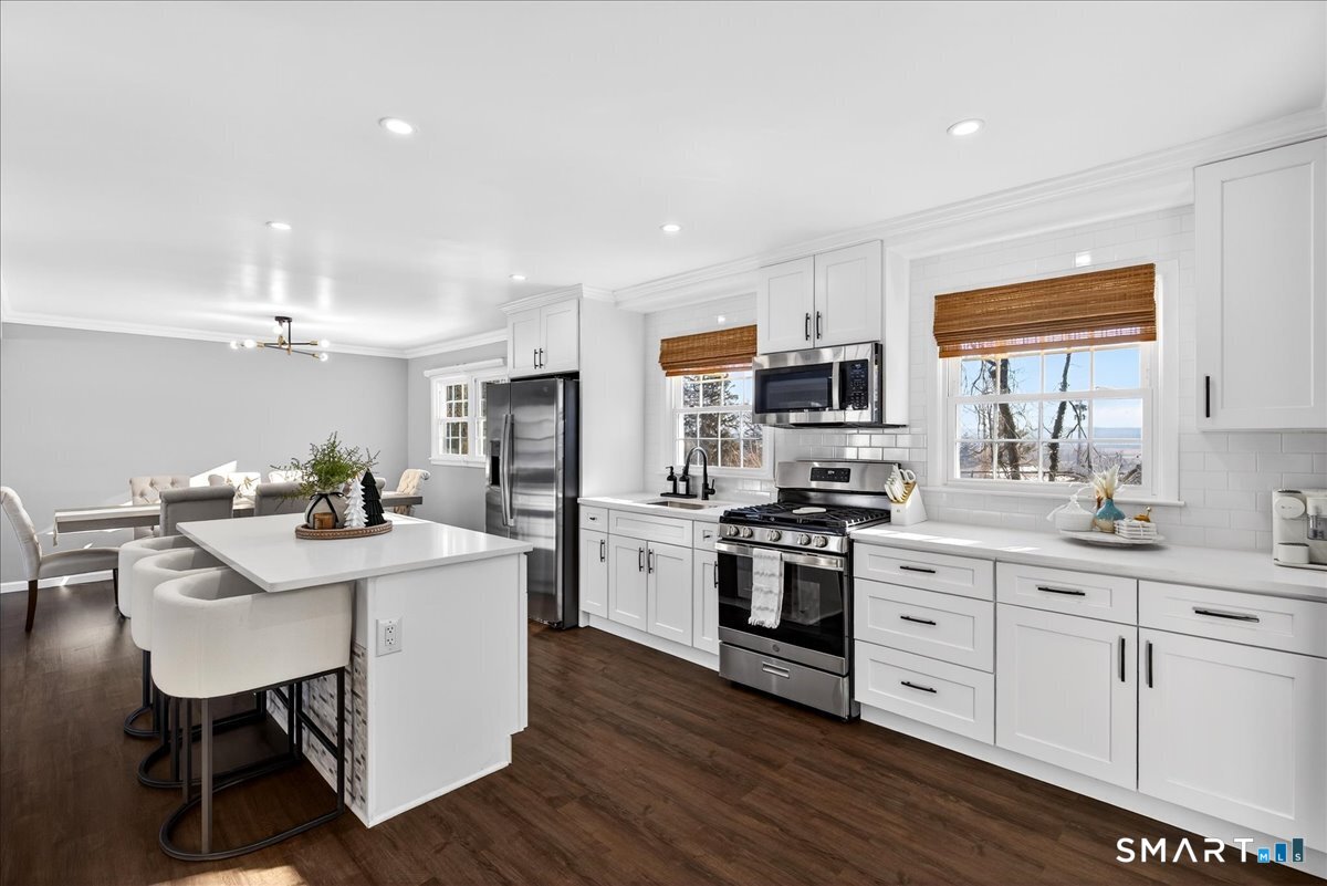 114 Daniel Road Hamden, CT 06517 - Photo 7 of 32 a kitchen with a sink stainless steel appliances and white cabinets