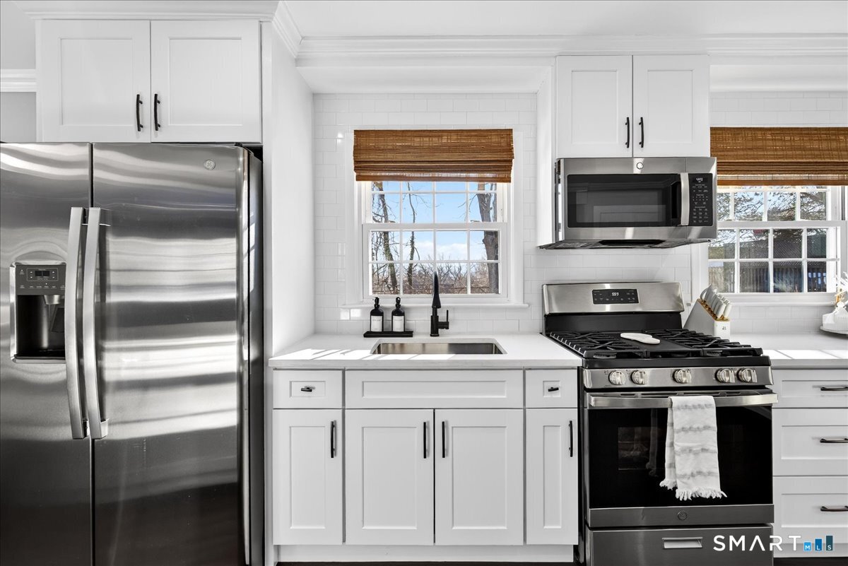 114 Daniel Road Hamden, CT 06517 - Photo 10 of 32 a kitchen with cabinets stainless steel appliances and a sink