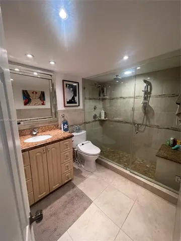 a bedroom with a bed and painting on the wall