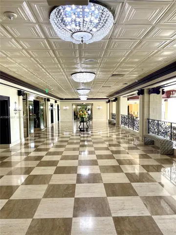 a view of a lobby with a chandelier and rug