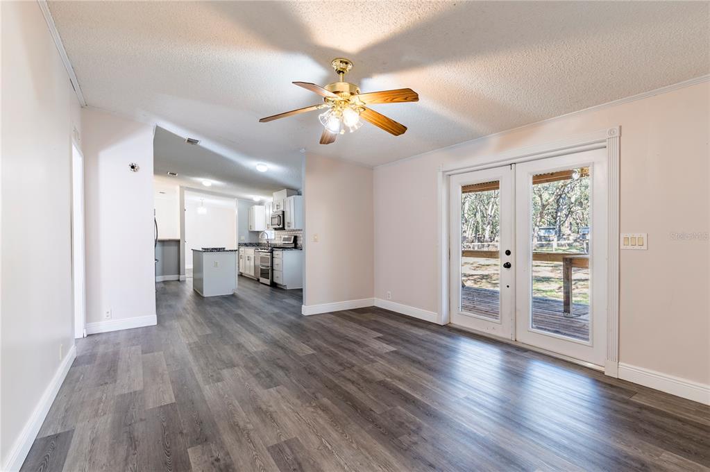 16314 Tiger Trail Spring Hill, FL 34610 - Photo 21 of 43 a view of empty room with wooden floor