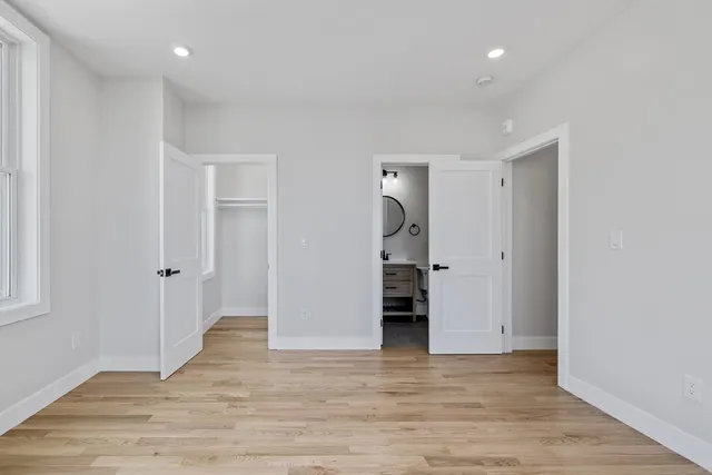 a view of room with window and wooden floor