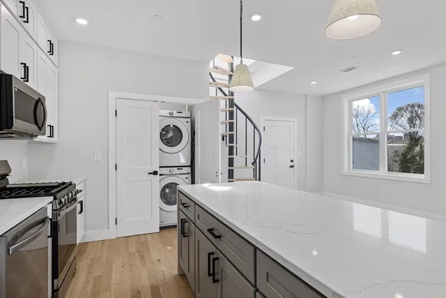 a kitchen with kitchen island a counter space a sink and appliances