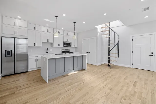 a kitchen with stainless steel appliances a refrigerator sink and cabinets
