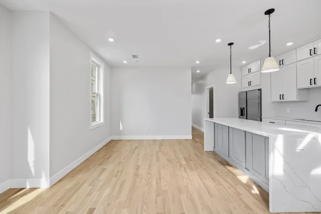 a view of kitchen with wooden floor and window