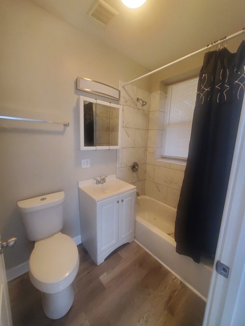 711 West 74th Street, Unit 1 Chicago, IL 60621 - Photo 8 of 9 a bathroom with a sink toilet and shower