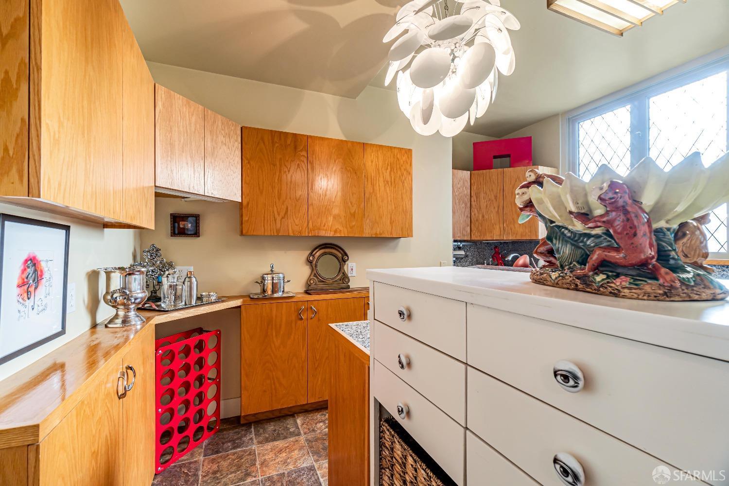 850 Powell Street, Unit 603 San Francisco, CA 94108 - Photo 15 of 47 a kitchen with stainless steel appliances a sink dishwasher stove refrigerator and cabinets with wooden floor