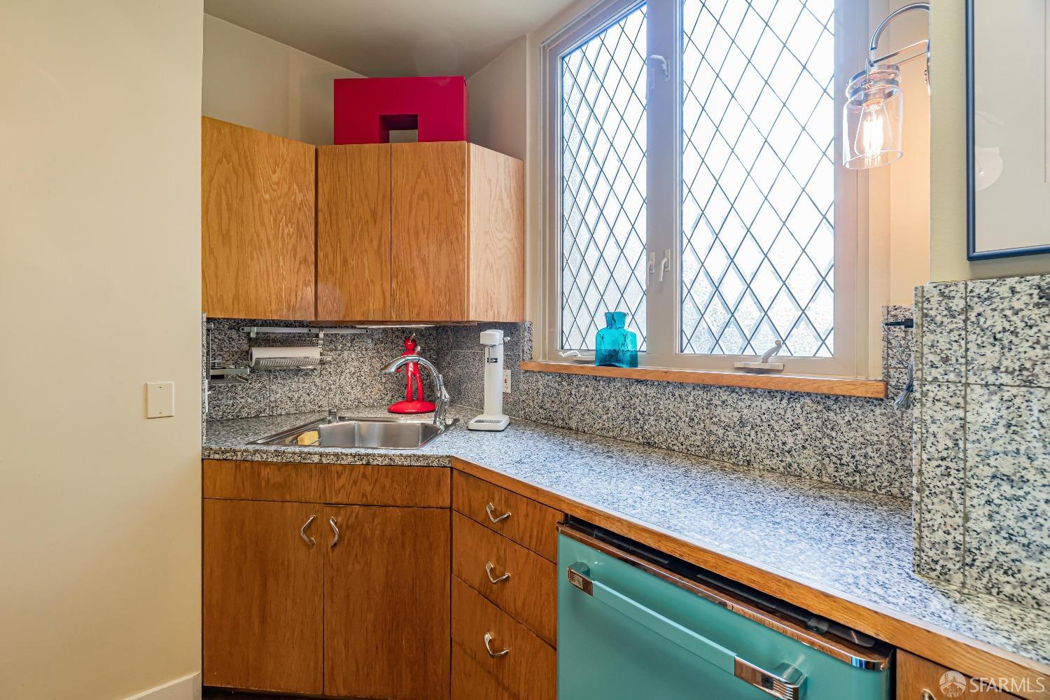 850 Powell Street, Unit 603 San Francisco, CA 94108 - Photo 17 of 47 a bathroom with a sink and a mirror