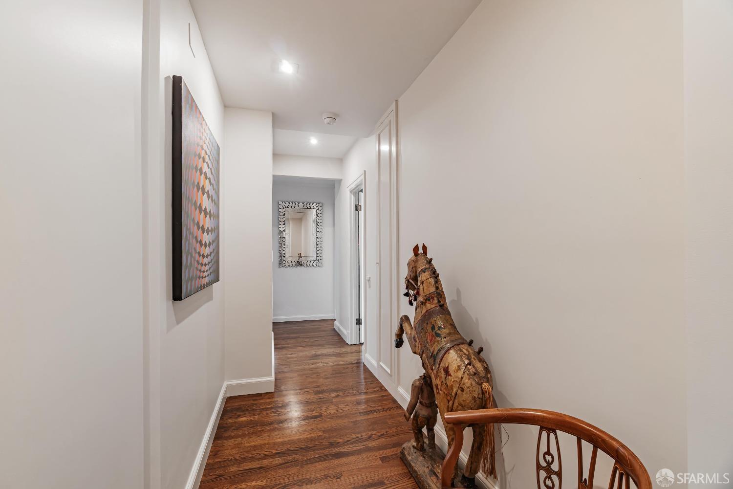 850 Powell Street, Unit 603 San Francisco, CA 94108 - Photo 25 of 47 a view of a hallway with wooden floor and stairs