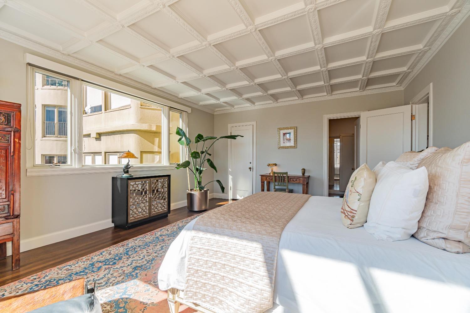 850 Powell Street, Unit 603 San Francisco, CA 94108 - Photo 31 of 47 a spacious bedroom with a large bed and a large window