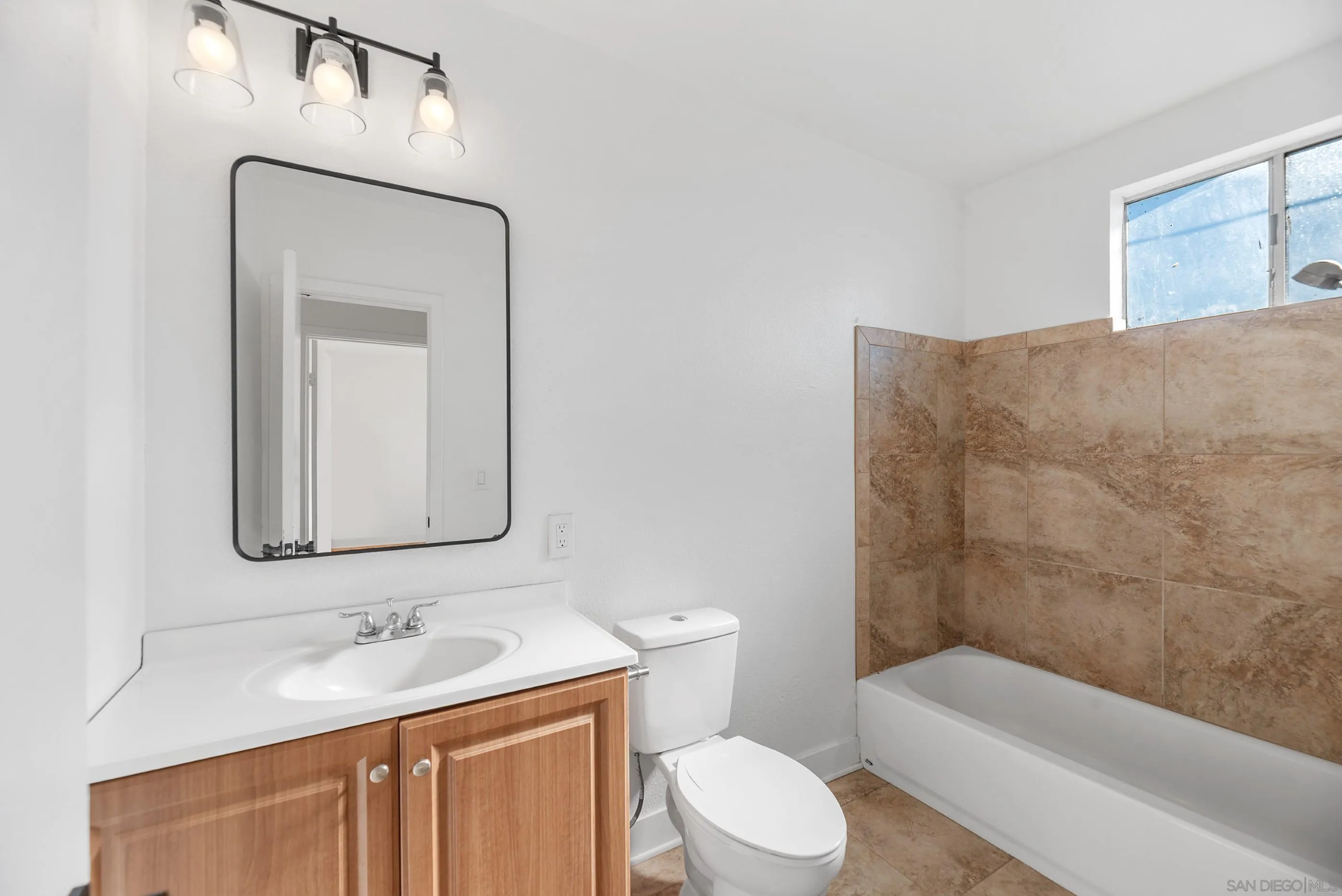 628 Paraiso Avenue Spring Valley, CA 91977 - Photo 15 of 38 a bathroom with a toilet a sink and bathtub