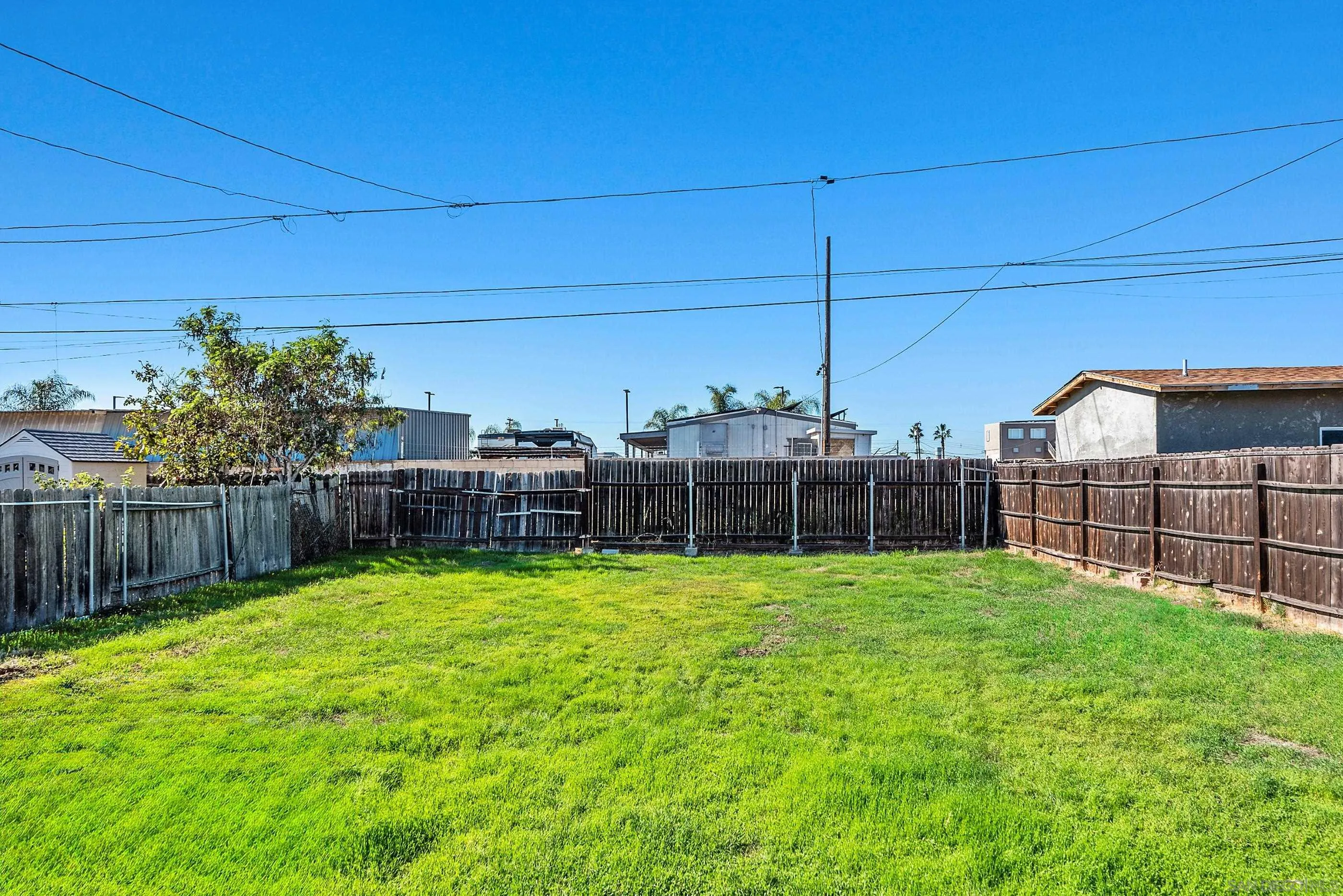 628 Paraiso Avenue Spring Valley, CA 91977 - Photo 32 of 38 a view of a backyard with potted plants and wooden fence