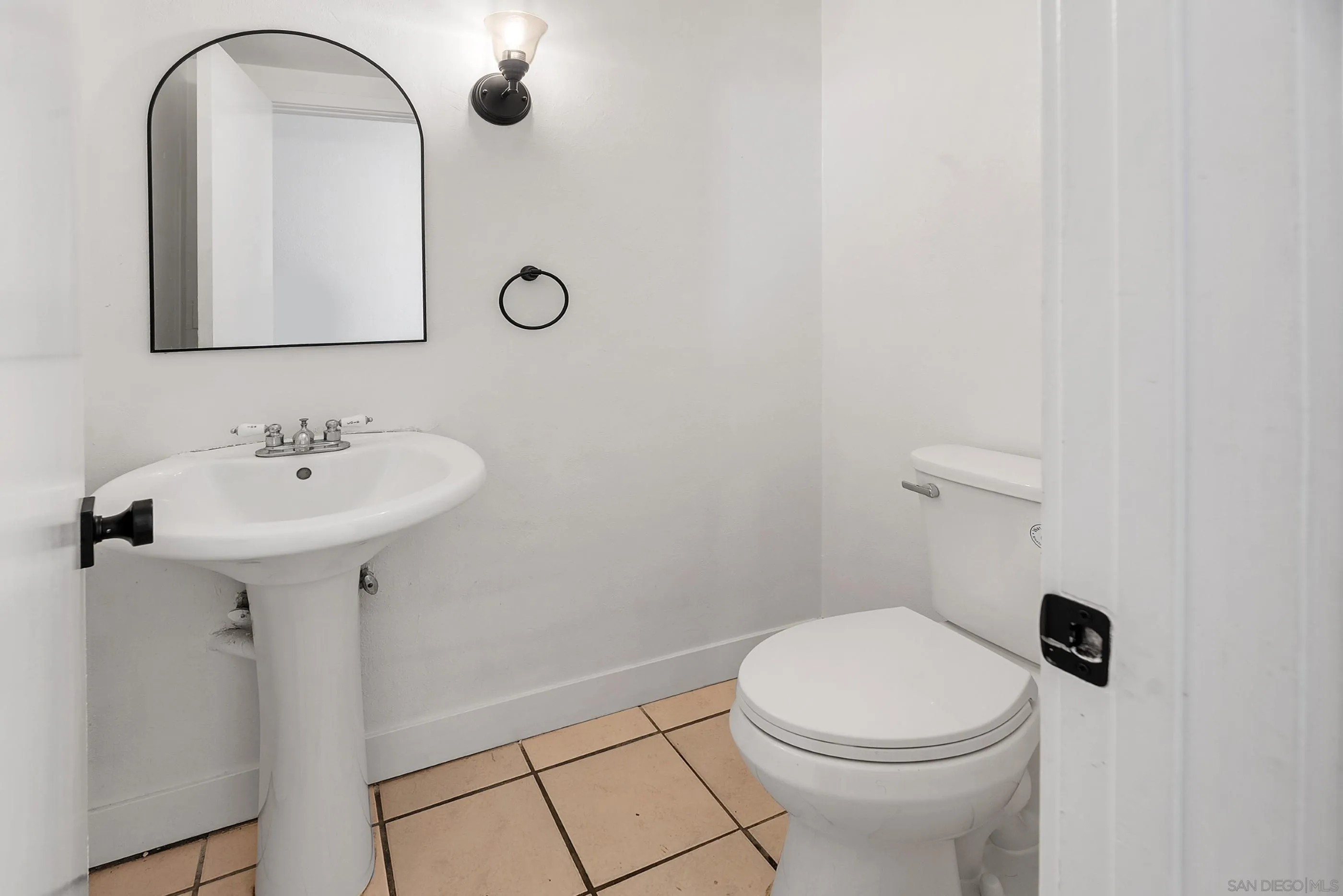 628 Paraiso Avenue Spring Valley, CA 91977 - Photo 37 of 38 a bathroom with a sink a toilet and mirror