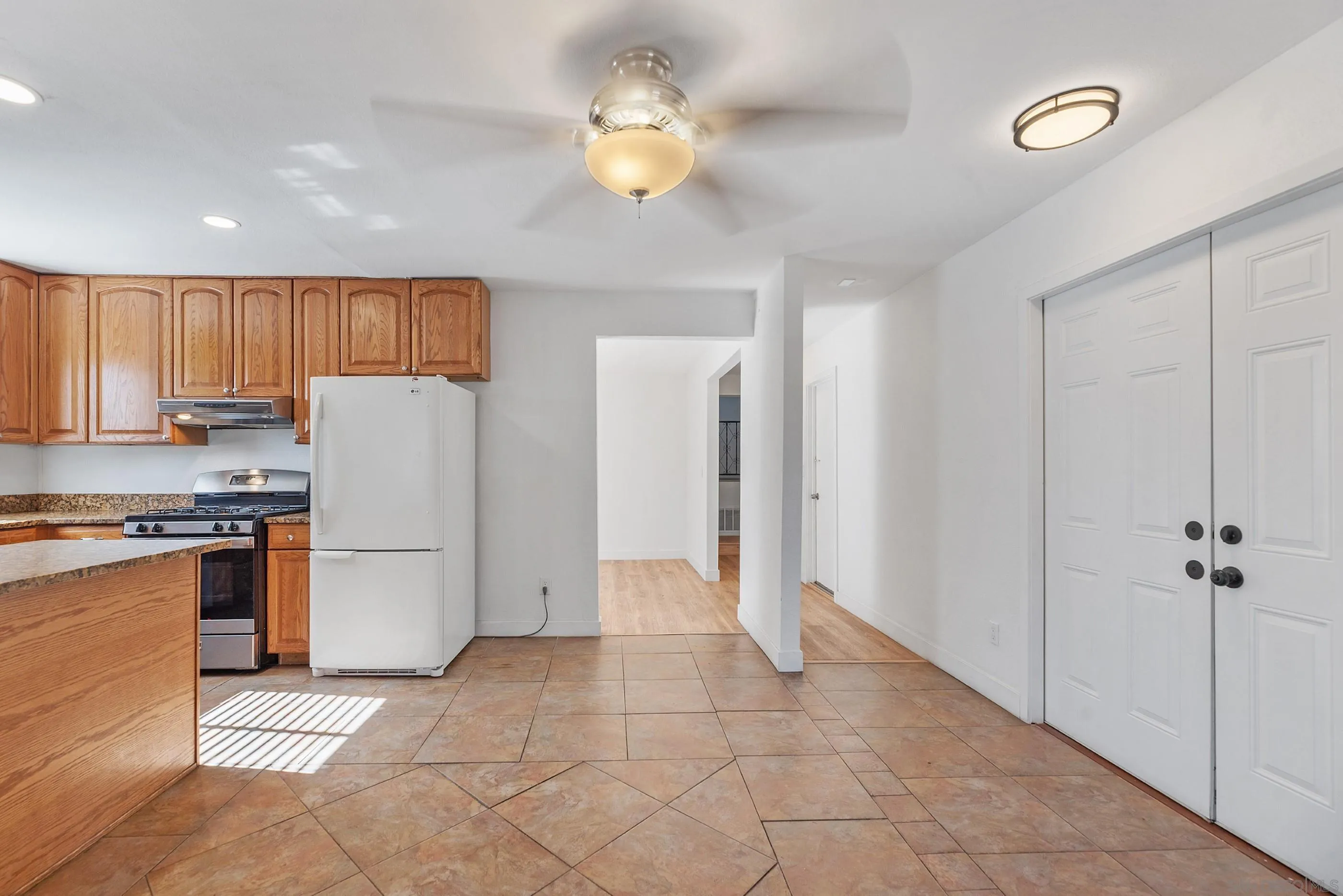 628 Paraiso Avenue Spring Valley, CA 91977 - Photo 5 of 38 a view of kitchen with stainless steel appliances granite countertop a refrigerator and a stove top oven