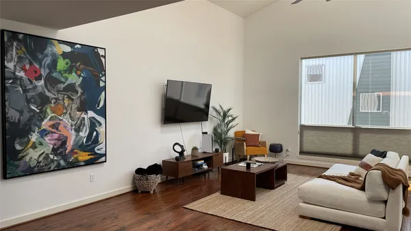 a living room with furniture and wooden floor