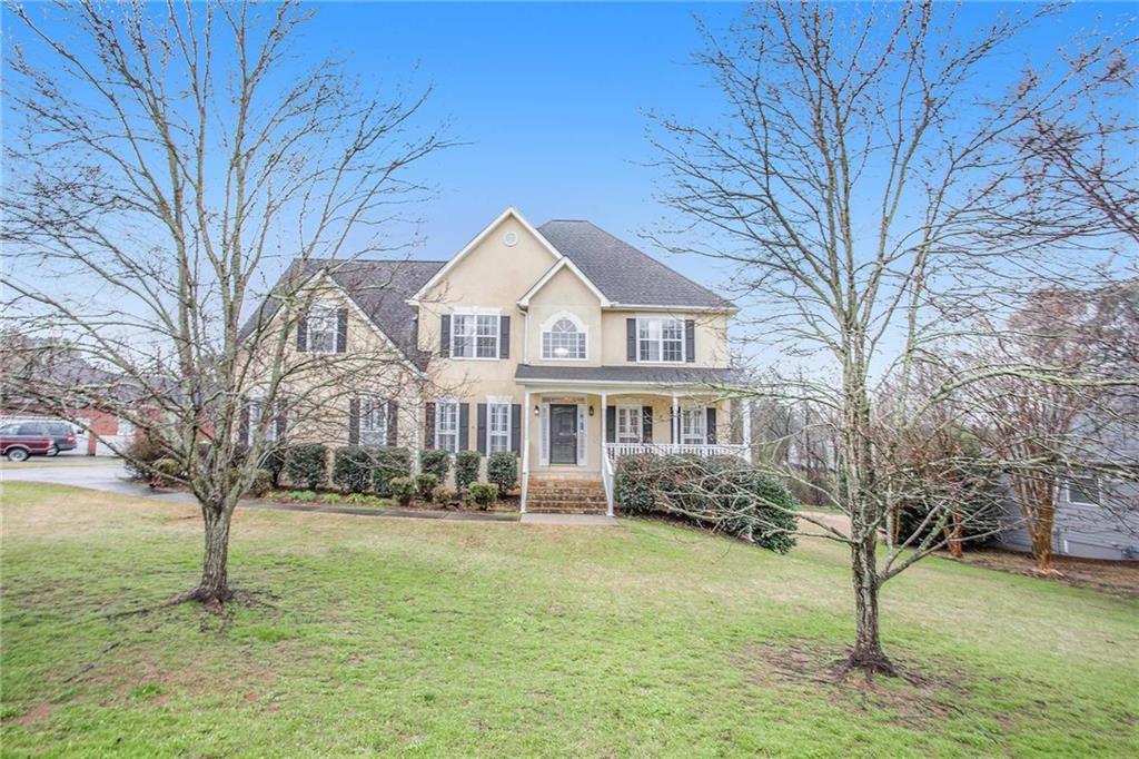 a front view of a house with a garden
