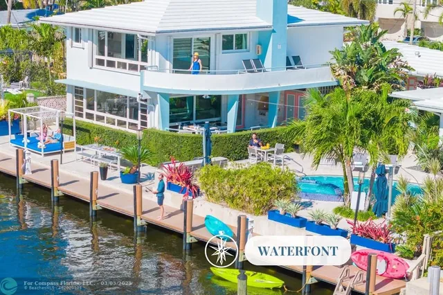 a view of a house with swimming pool and sitting area
