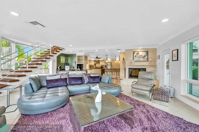 a living room with fireplace furniture and a rug