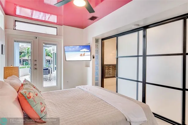 a bedroom with a bed and a large window