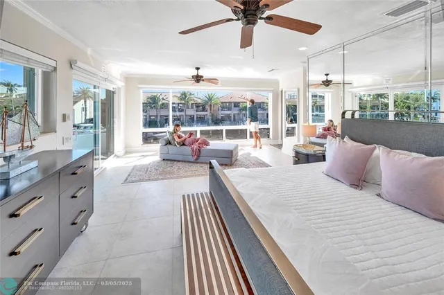 a spacious bedroom with a large bed and a large window