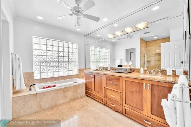 a large white kitchen with a large window