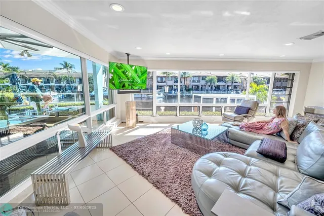 a living room with patio furniture and a garden
