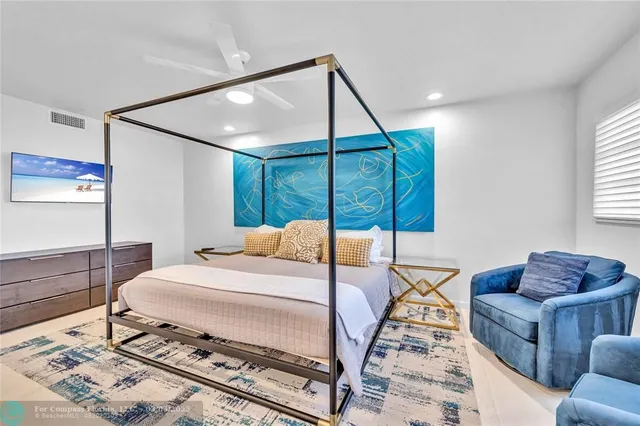 a bedroom with a bed a couch and a window