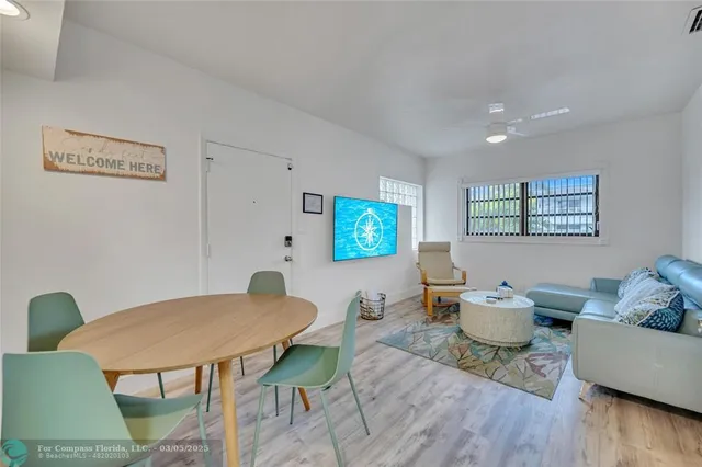 a living room with furniture a rug and a table
