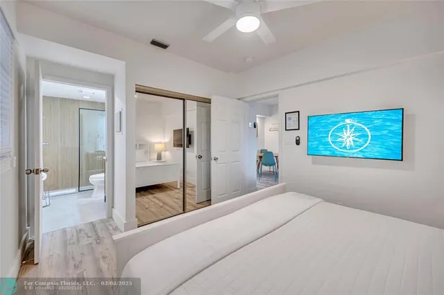 a bedroom with a bed and a view of bathroom