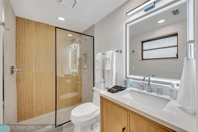 a bathroom with a sink toilet and shower
