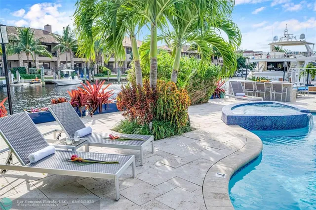 a view of swimming pool with outdoor seating