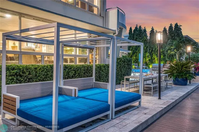 a view of a patio with dining table and chairs with wooden floor