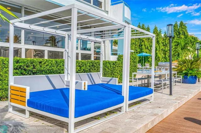 a view of a patio with table and chairs potted plants with wooden floor and fence