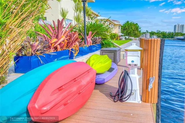 a view of a swimming pool with a chairs in a patio