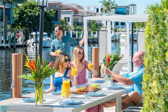 a view of outdoor space with seating area and trees in the background