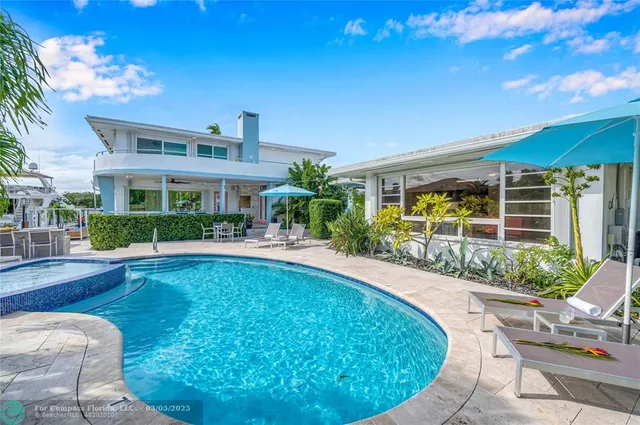 a view of a house with swimming pool and a porch