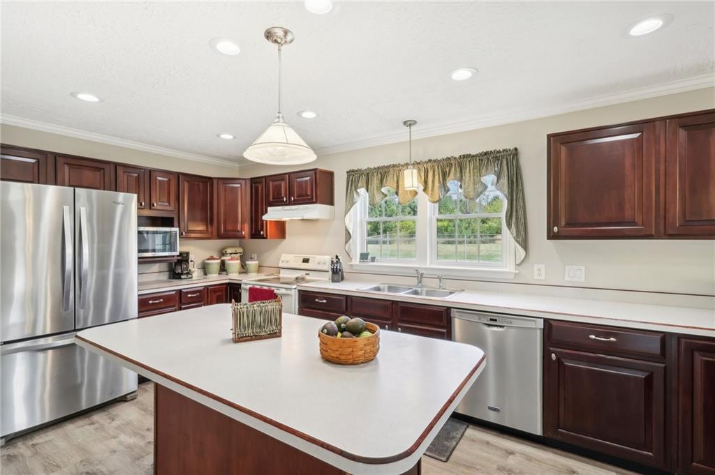 174 Hollow Road Darlington, PA 16115 - Photo 17 of 50 a kitchen with a sink a stove and chairs