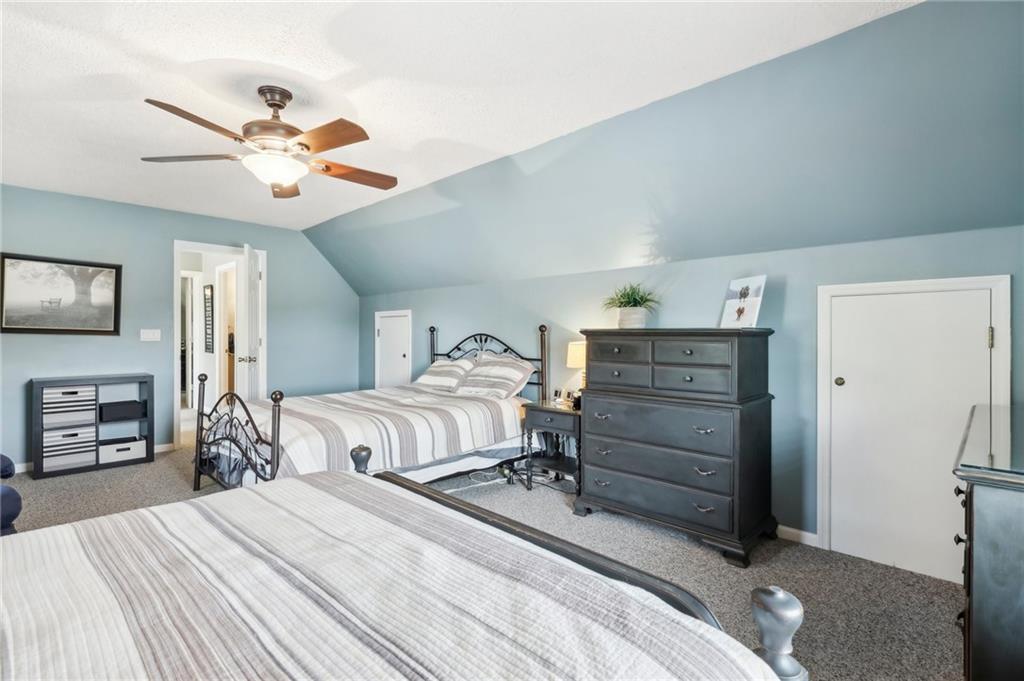 174 Hollow Road Darlington, PA 16115 - Photo 30 of 50 a bedroom with a bed and a chandelier