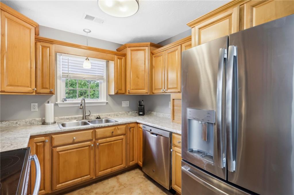 174 Hollow Road Darlington, PA 16115 - Photo 35 of 50 a kitchen with stainless steel appliances granite countertop a refrigerator and a sink
