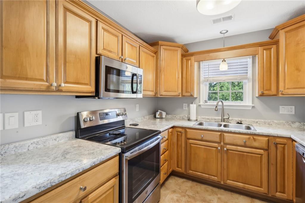 174 Hollow Road Darlington, PA 16115 - Photo 36 of 50 a kitchen with stainless steel appliances granite countertop a sink a stove and cabinets