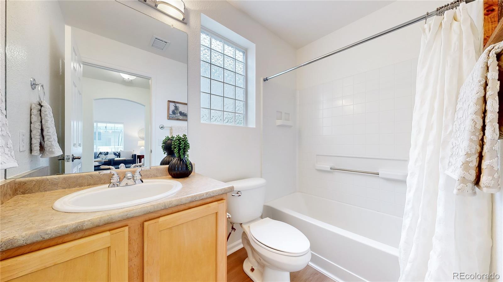 11738 Zenobia Loop Westminster, CO 80031 - Photo 15 of 34 a bathroom with a granite countertop sink toilet and shower