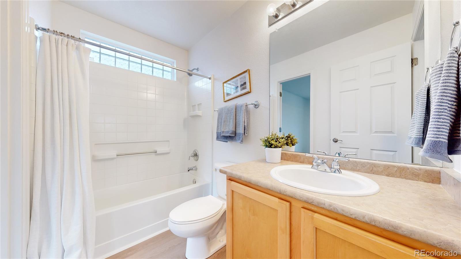 11738 Zenobia Loop Westminster, CO 80031 - Photo 18 of 34 a bathroom with a granite countertop sink toilet and shower