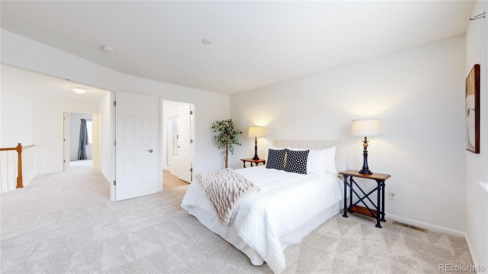 11738 Zenobia Loop Westminster, CO 80031 - Photo 20 of 34 a bedroom with a bed and a lamp