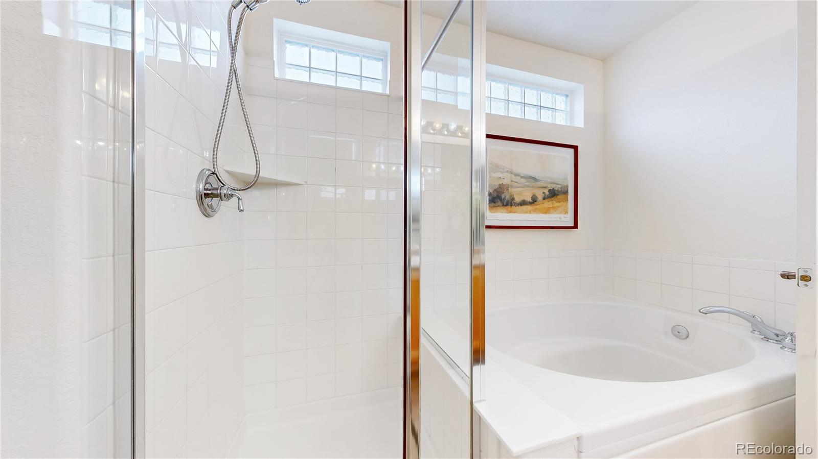 11738 Zenobia Loop Westminster, CO 80031 - Photo 23 of 34 a bathroom with a tub and shower