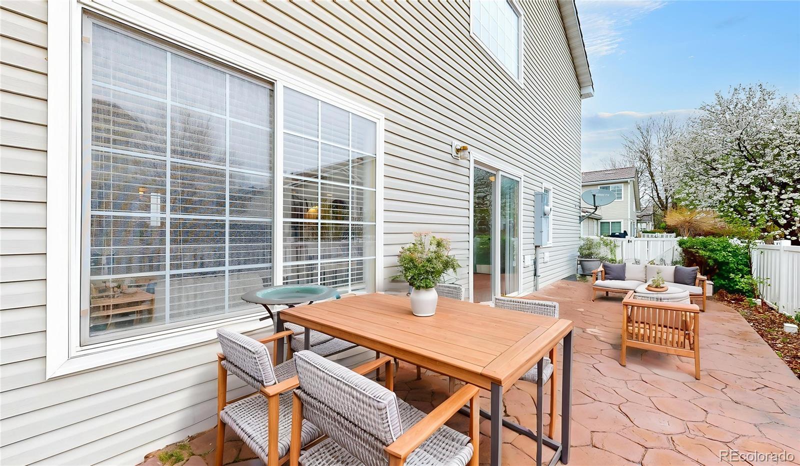 11738 Zenobia Loop Westminster, CO 80031 - Photo 25 of 34 a view of a patio with a table and chairs and potted plants