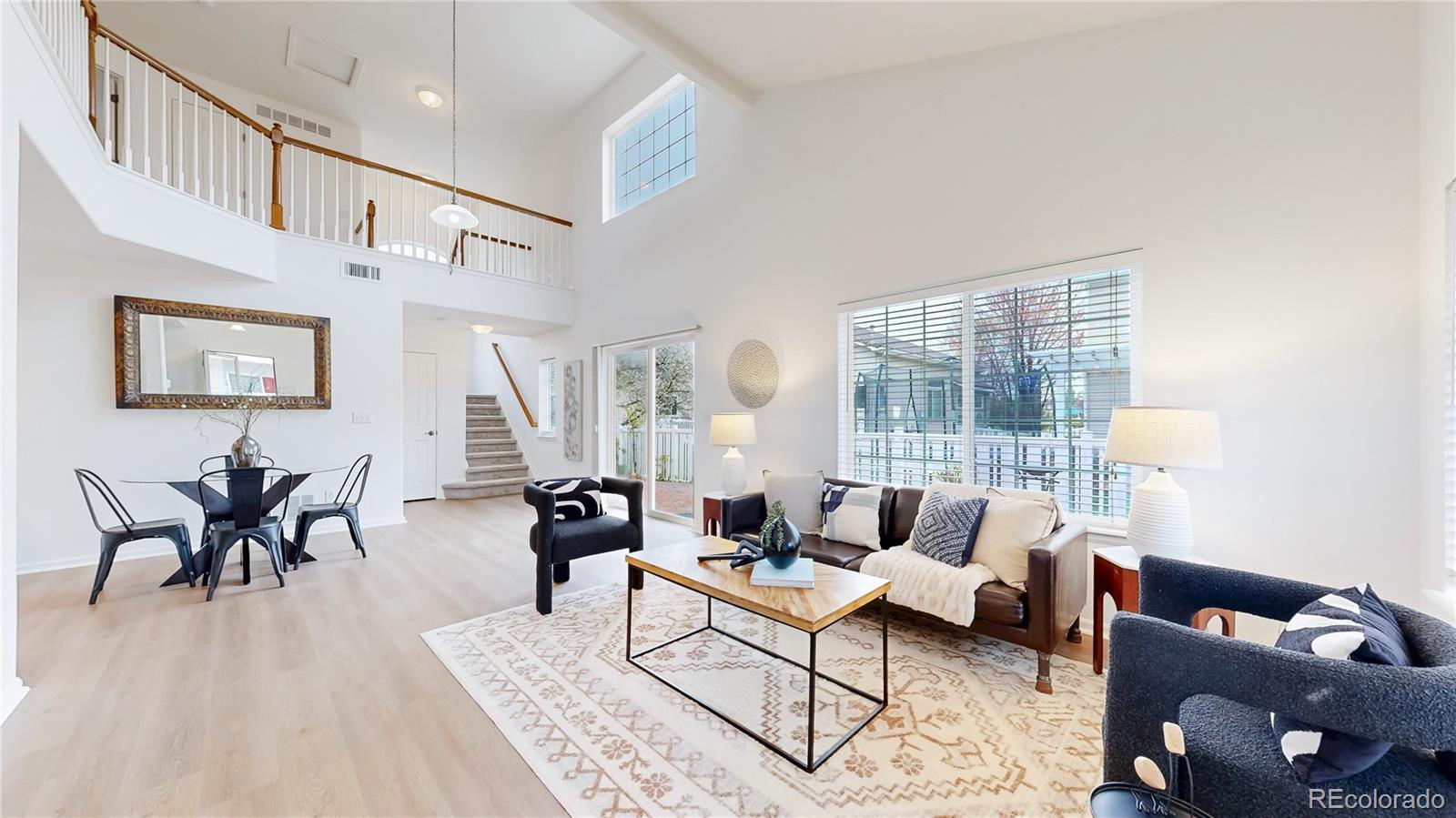 11738 Zenobia Loop Westminster, CO 80031 - Photo 4 of 34 a living room with furniture and floor to ceiling windows