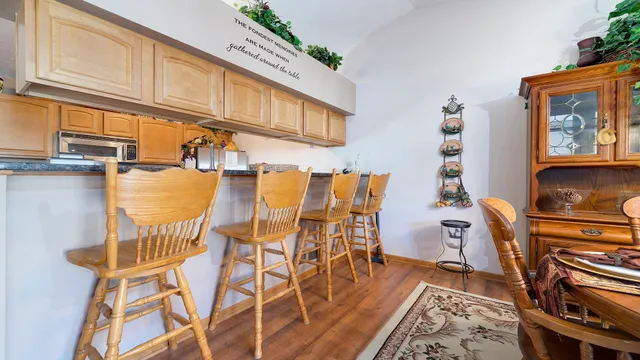 a dining room with furniture a rug and wooden floor